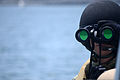 A U.S. Sailor assigned to Coastal Riverine Squadron 1 searches for surface contacts while patrolling San Diego Bay during the squadron's final evaluation problem (FEP) May 21, 2013 130521-N-FN215-491.jpg